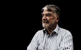 Simon Karkow on black background striped shirt